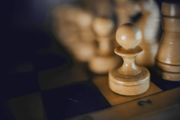 istock White's pieces on the chessboard, top view. 1305859593
