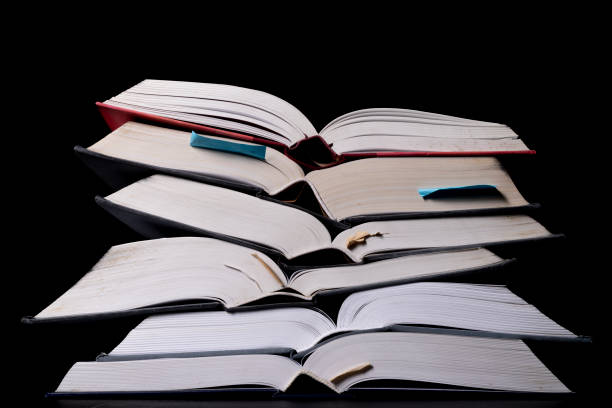 istock A stack of books on the desk. Old extensive literary publications. Dark background. 1305859607