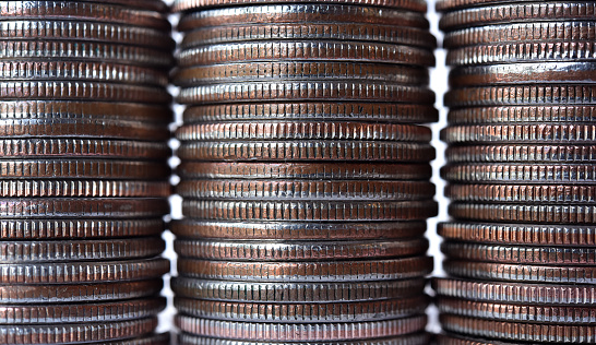 Three Stacks of US quarters side by side with the  center stack slightly near to the camera.