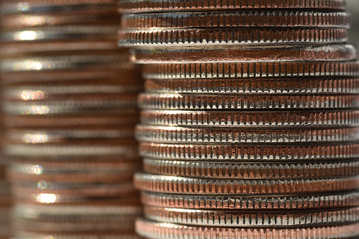 Three stacks of well used quarters into the distance.