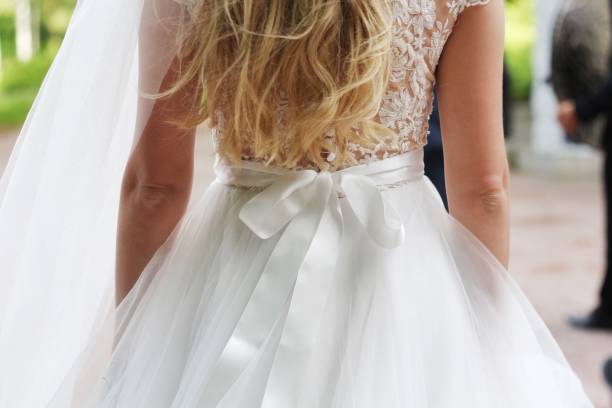 istock Silk bow on wedding dress. Long hair. 1305863340