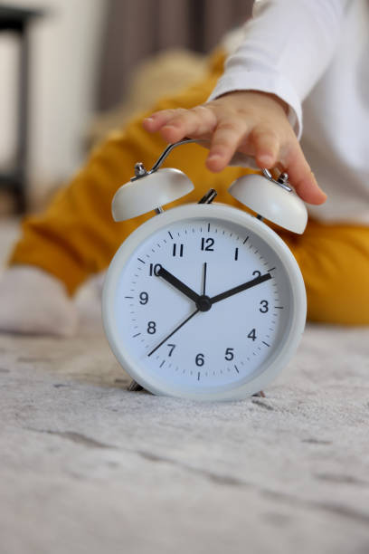 istock The baby is holding an alarm clock 1305865127