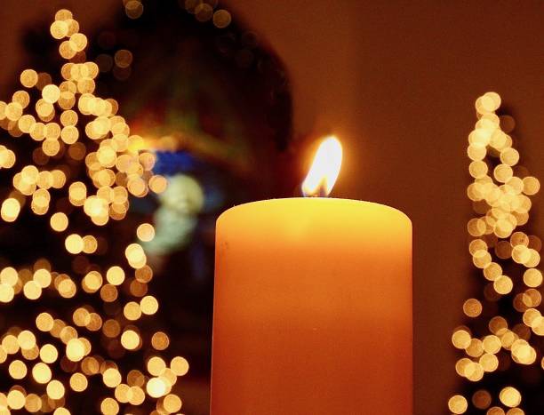 istock Single Candle In Church At Christmas Time 1305868480
