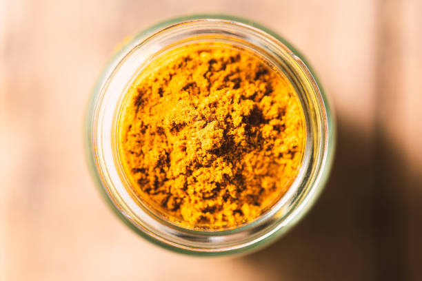 istock Turmeric powder in glass jar 1305869034