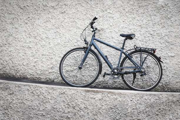 istock Bicycle parked against grungy stone wall 1305875753