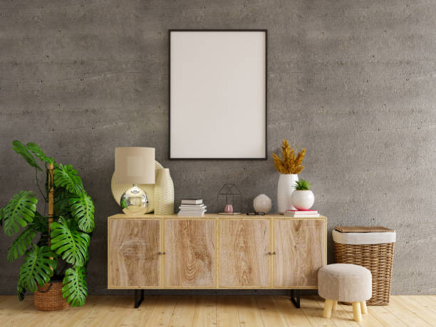 istock Mockup frame on cabinet in living room interior on empty concrete wall background. 1305880615