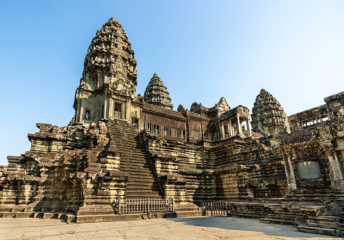 Angkor Wat, Cambodia - January 22, 2020: The third level court of Angkor Wat is lit by the rising Sun. The Angkor Wat is a Hindu temple complex in Cambodia and is the largest religious monument in the world.