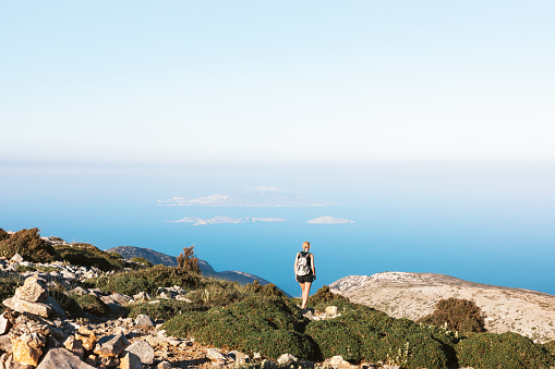 Woman hiking down of Mount Zas, which is the highest point in the Cyclades (Naxos island, Greece).