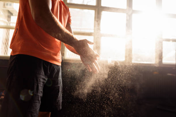 istock Unrecognizable young man clapping hands with sports chalk in a gym 1305883508