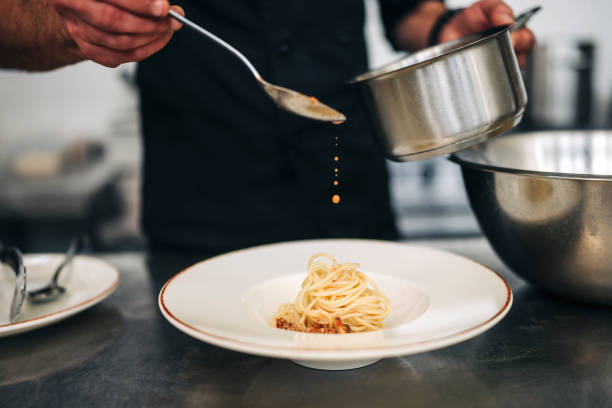 istock Male chef prepare pasta in restaurants kitchen 1305883826