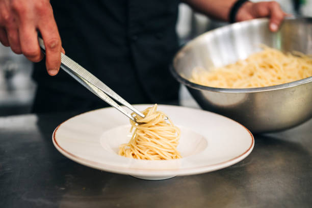 istock Male chef prepare pasta in restaurants kitchen 1305883828