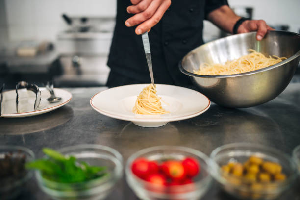 istock Male chef prepare pasta in restaurants kitchen 1305883830