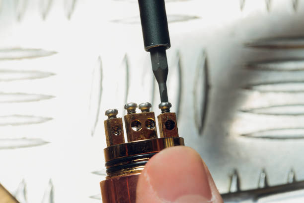 istock Specialist replaces spring for smoking vape.Professional maintaining electronic cigarette in shop.Fix broken vaping device and quit smoking nicotine cigarettes. 1305884152