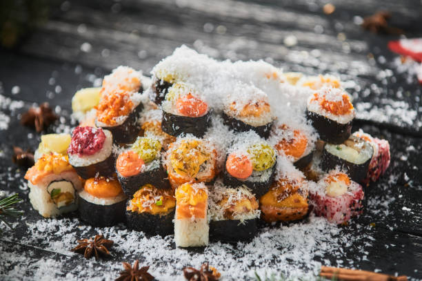 istock sushi set and sushi roll on wooden board. 1305884220