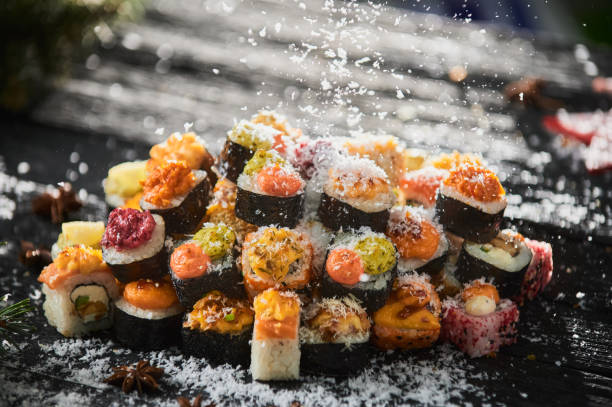 istock sushi set and sushi roll on wooden board. 1305884222