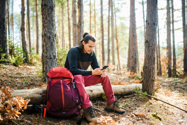 istock Young man using a smart phone in the nature. 1305884307