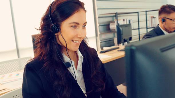 istock Business people wearing headset working in office 1305888382