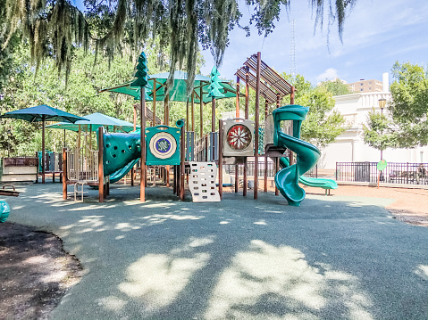 A playground waits for the children who will come and play. This inviting park is framed by hanging Spanish Moss, creating an inviting scene.