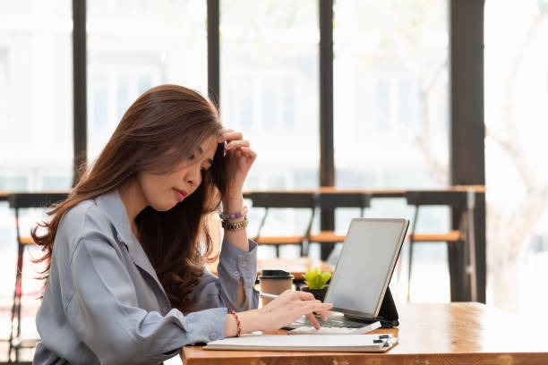 istock Asian woman working with tablet while reading data on notebook. Student girl working at home. Work or study from home, freelance, business, lifestyle concept 1305896294