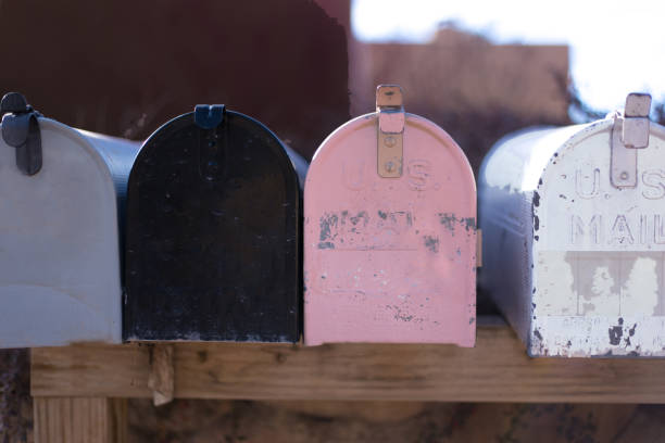 istock Line of Colorful Old-Fashioned Rural US Mailboxes 1305897112