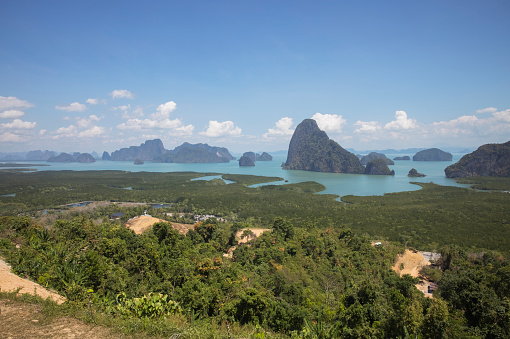 Samet Nangshe Viewpoint at Phang-nga Province, Thailand. There are many seas and islands with white clouds in the sky. Concept about resort, travel, nature, landscape, health.