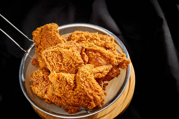 istock crispy fried chicken in a black luxury satin background 1305900243