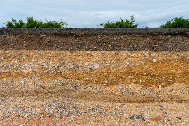 istock The layer of asphalt road with soil and rock 1305901786