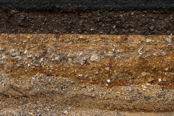 istock The layer of asphalt road with soil and rock 1305901787