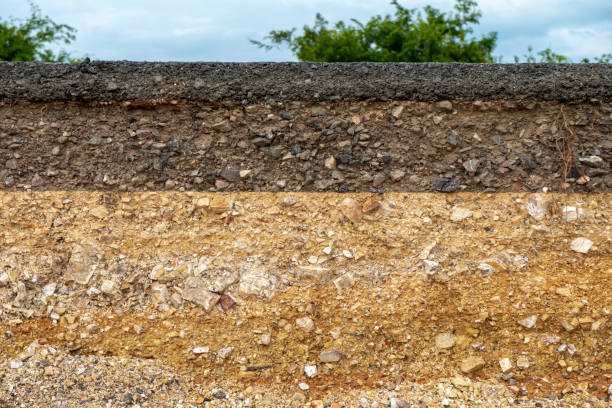 istock The layer of asphalt road with soil and rock 1305901788