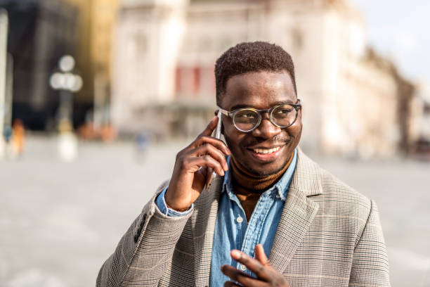 istock Happy young man talking on phone in the city. 1305901859