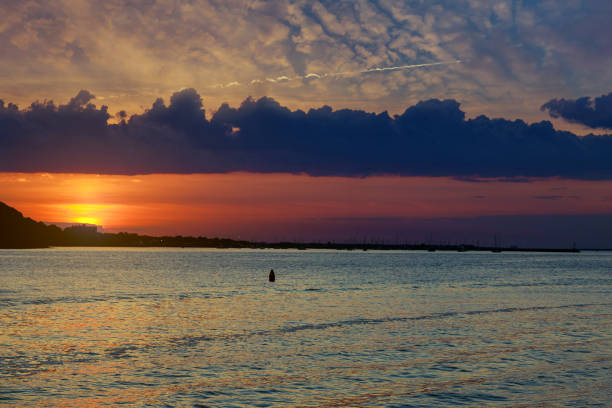 istock Sunrise over the ocean with beautiful cloudscape 1305902847