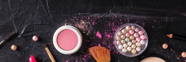istock Make-up products and tools panorama, shot from the top on a black background 1305905430
