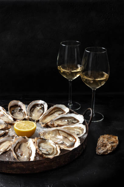 istock Oysters on a platter, with lemon and wine 1305905446