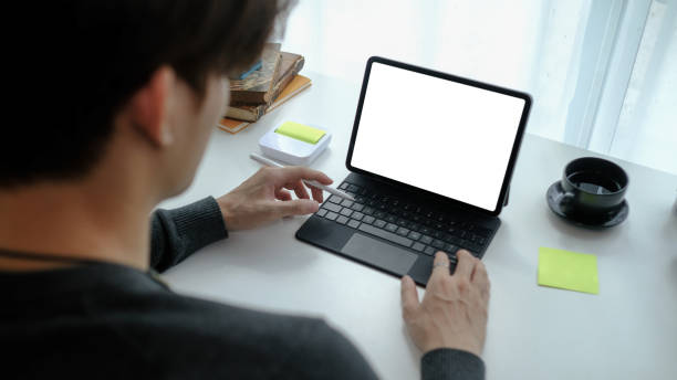 istock Close up view man freelancer working on computer tablet at home. 1305905612