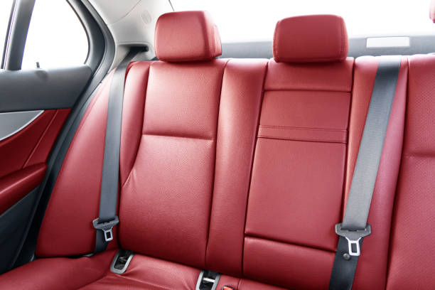 istock Back passenger red leather seats in modern luxury car. Red perforated leather with stitching. Car inside. Leather comfortable red seats. Car interior details 1305906235