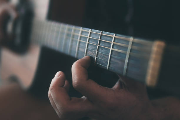 istock close up of a man playing guitar 1305907060