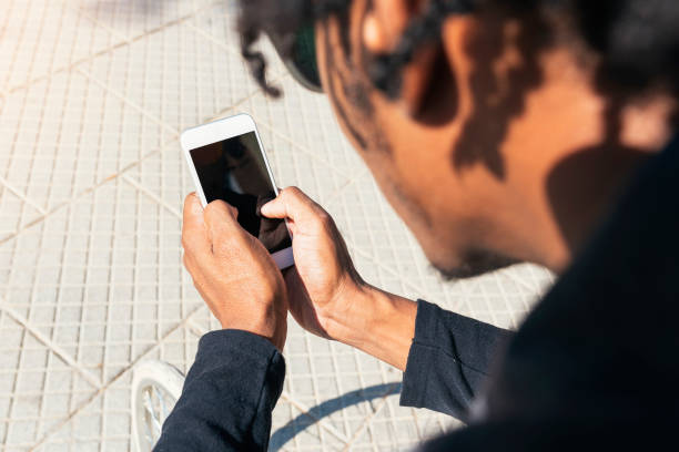istock Close up of young man using mobile phone. 1305909499