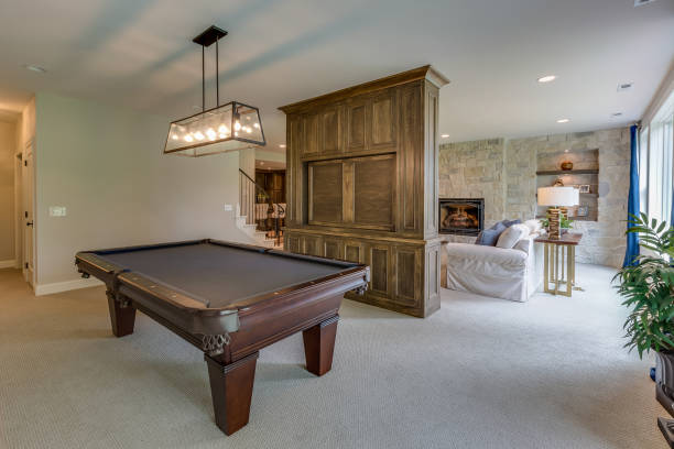 Game room in basement of new home Custom built home with plenty of space for entertaining and enjoying games with company basement stock pictures, royalty-free photos & images