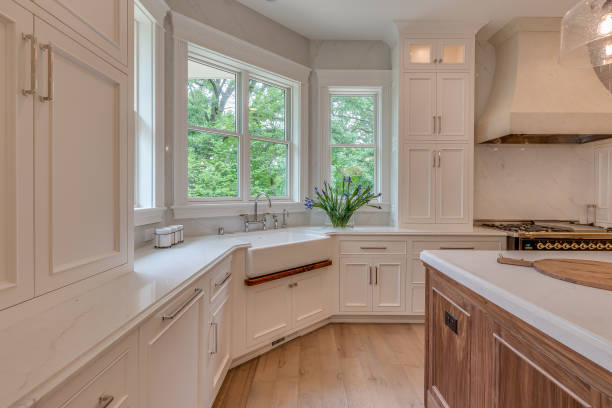 istock Beautiful white farm style sink in white kitchen 1305909534