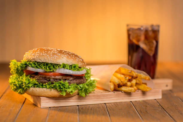 istock Delicious hamburger with vegetables on wooden board 1305911340