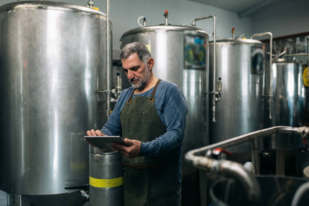 istock man working in his mini craft brewery 1305911487