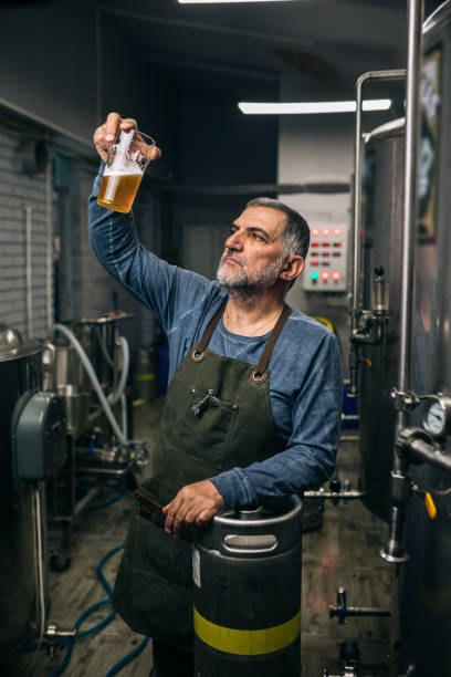 istock man working in his mini craft brewery 1305911602