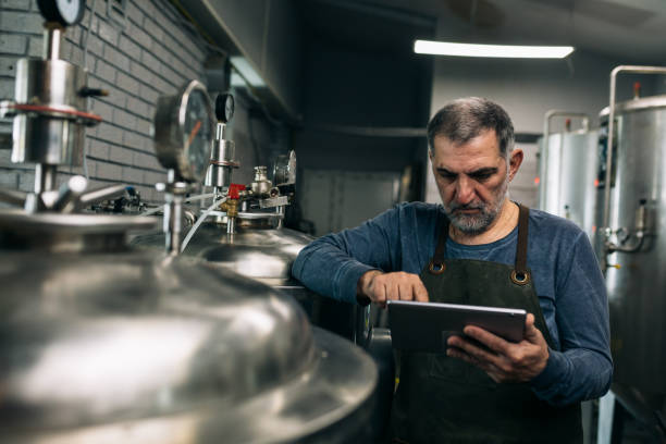 istock man working in his mini craft brewery 1305911630