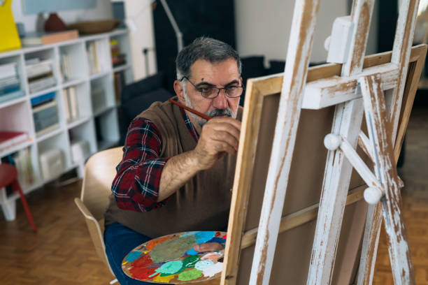 istock man painting picture at home 1305911706