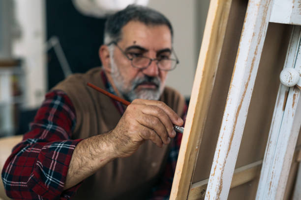 istock man painting picture at home 1305911713