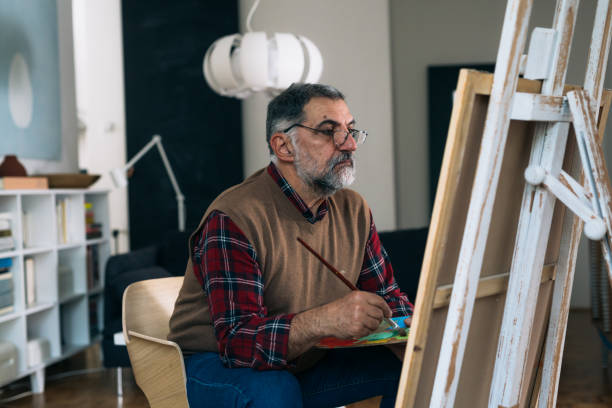 istock man painting picture at home 1305912347