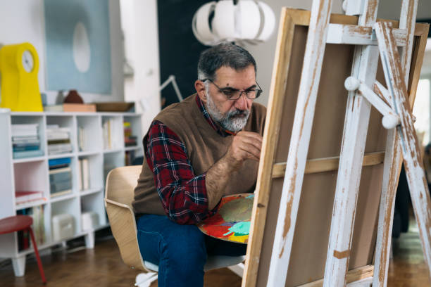 istock man painting picture at home 1305912443