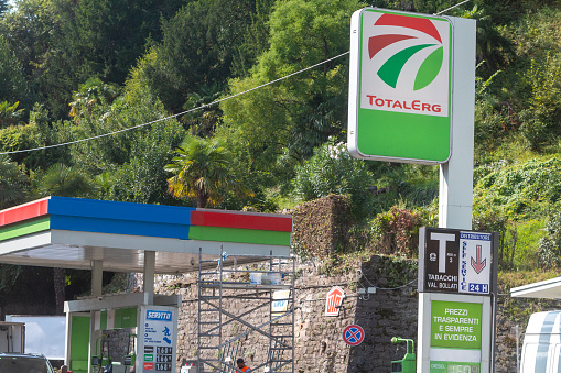 TotalErg Service Station in Menaggio, Italy, with various commercial signs and symbols visible