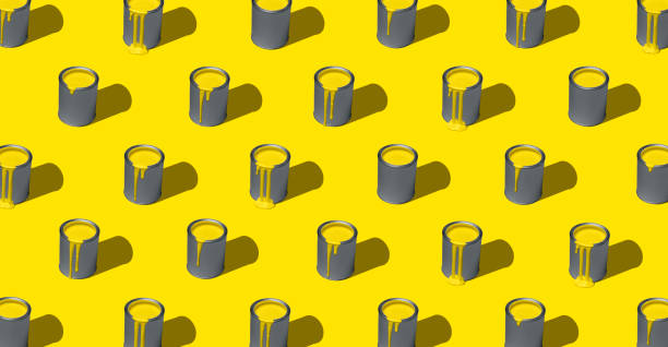 vernice gialla in lattina, motivo, isolata su sfondo giallo. simmetria delle lattine di vernice, full-frame - pantone 2021 foto e immagini stock