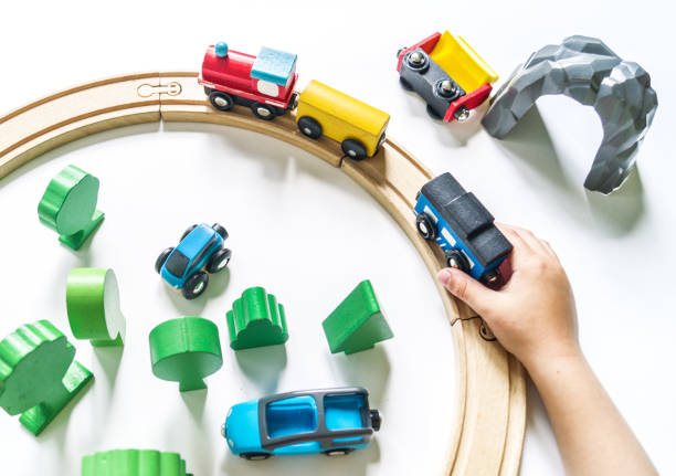 istock Wooden railway. A boy plays a toy train. Flat lay. 1305914661